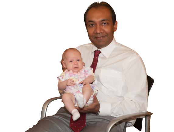 Dr. Kumara Siriwardena holding a newborn